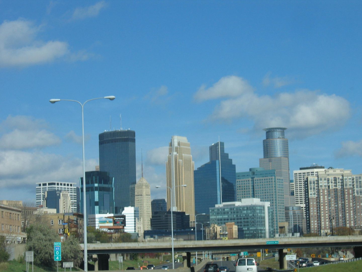 City skyline with skyscrapers and blue sky.