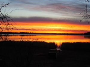 Vibrant sunset over a calm lake.