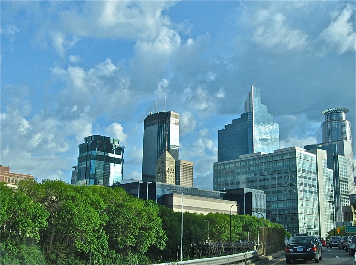 City skyline with skyscrapers and greenery.