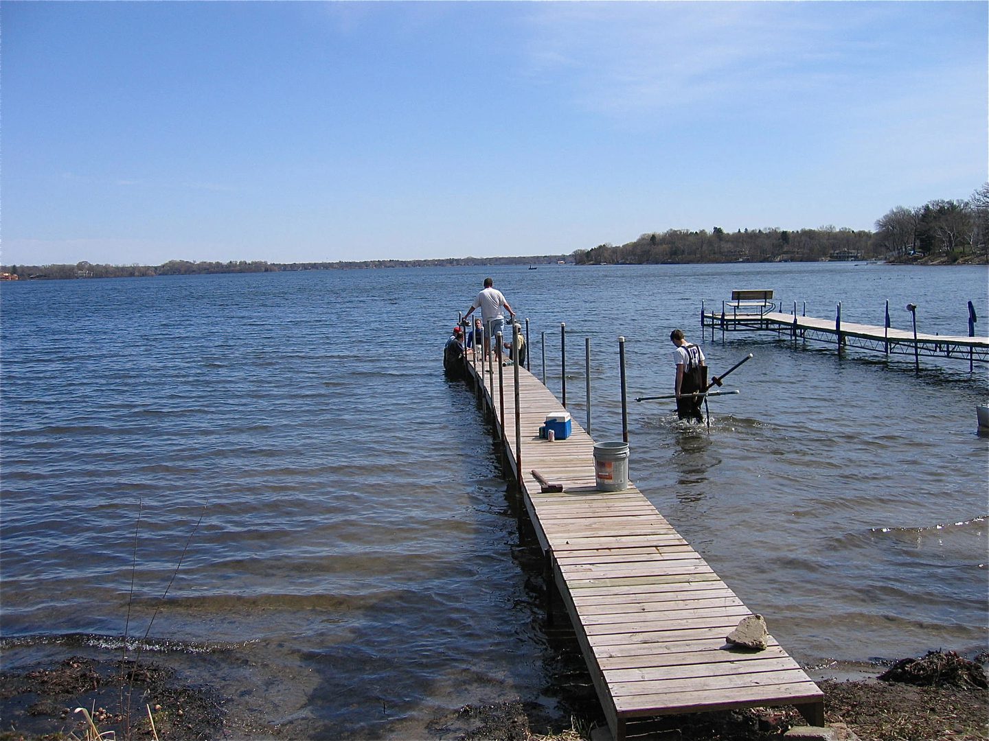 People working on a wooden dock construction.